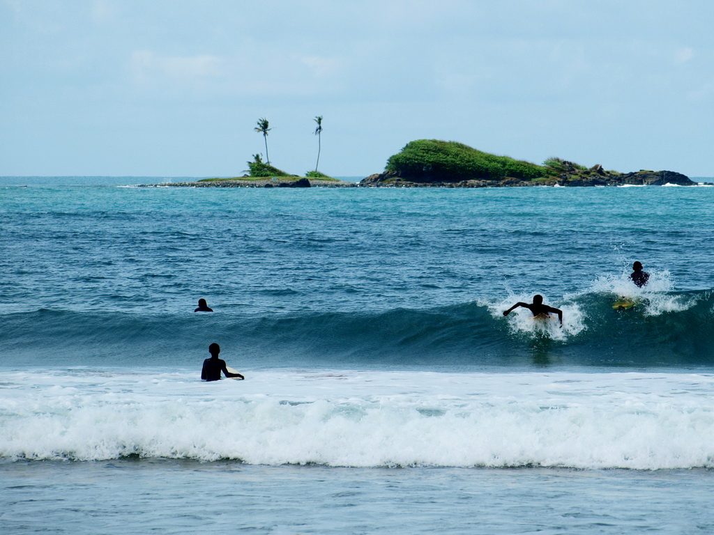 Surfers Surfing at Busua Beach in Western region, Ghana