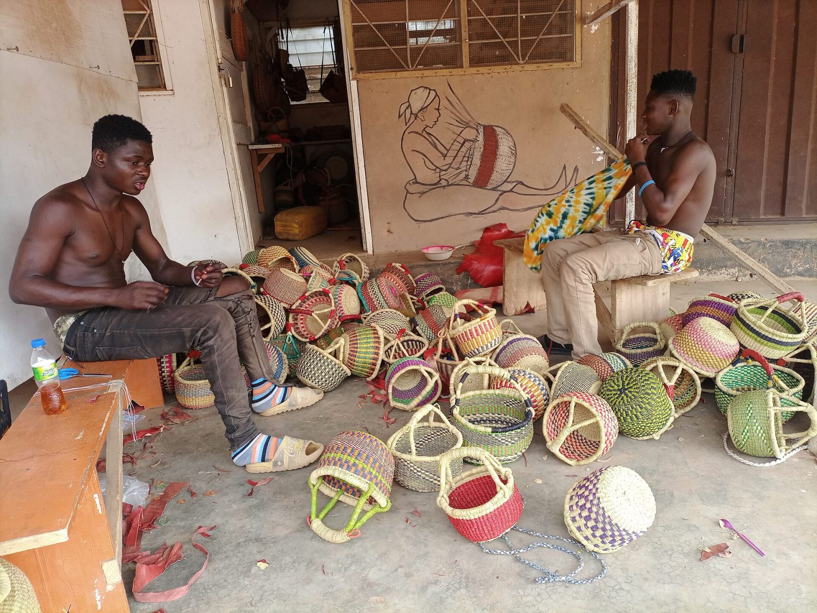 Weavers making colourful baskets at the Bolga market